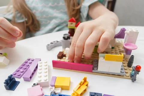 Child builds with constructor bricks, plays with toys Stock Photos