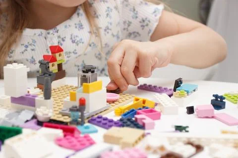Child builds with constructor bricks, plays with toys Stock Photos