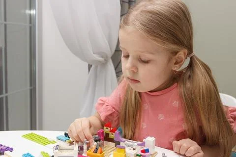 Child builds with constructor bricks, plays with toys Stock Photos