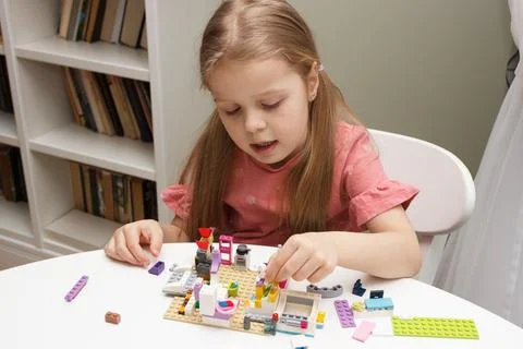 Child builds with constructor bricks, plays with toys Stock-Fotos