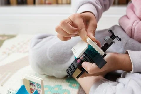 Child builds with constructor bricks, plays with toys Stock Photos