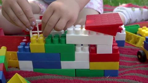 The child builds a house from colored cubes Stock Footage 215877188