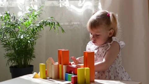 A child builds a tower of colored cubes. Stock Footage 194347481