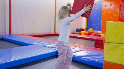 The child builds a tower of large soft bright cubes. Stock Footage 97262683