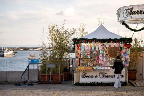 Child buying sweets at waterfront candy stand Stock Photos