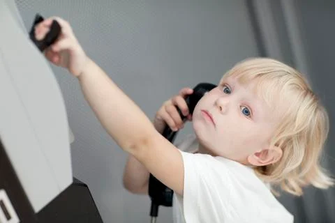 Child calling by the telephone Stock Photos