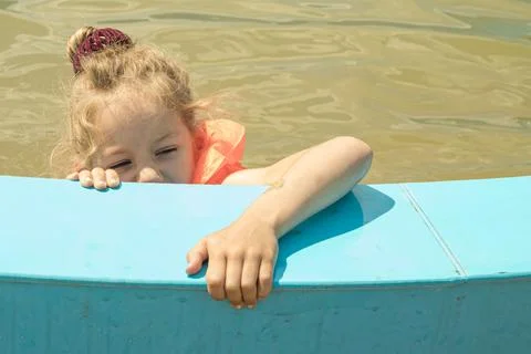 A child calls for help while swimming in the pool. Stock Photos