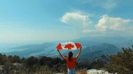 Child With Canadian Flag On Top Of Mountain, Girl Waving Canada Symbol Stock Footage