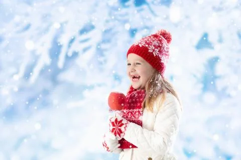 Child with candy apple on winter fair Stock Photos