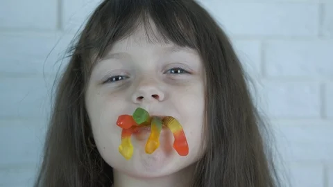 A child with candy worms. Stock Footage 124441133