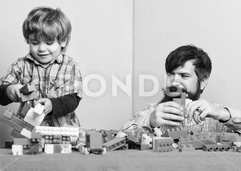 Child care development and upbringing. Father son game. Father and son create Stock Photos