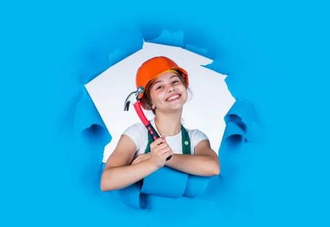 Child care development. Kid engineer with carpenter work hammer. Labor day at 1 Stock Photos