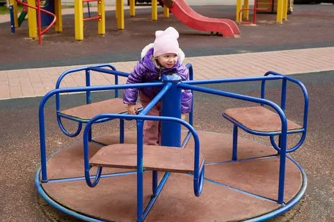 Child on a carousel on the playground Stock Photos