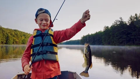 Child Catches Fish At Lake Stock Footage