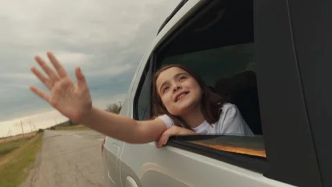 Child catching wind with hand sitting car, car trip, kids adventure family car Stock Footage 302746550