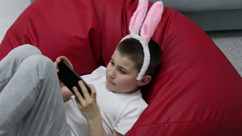 Child celebrate Easter at home using mobile cell phone Video stock 180374258