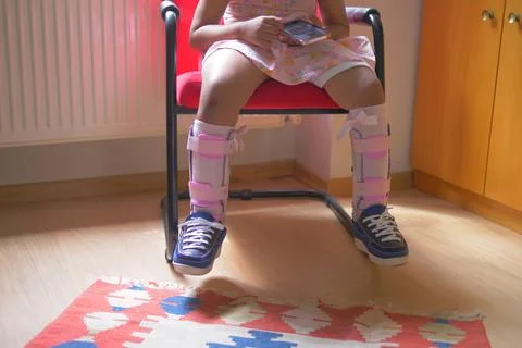 Child cerebral palsy disability, legs orthosis. Stock Photos