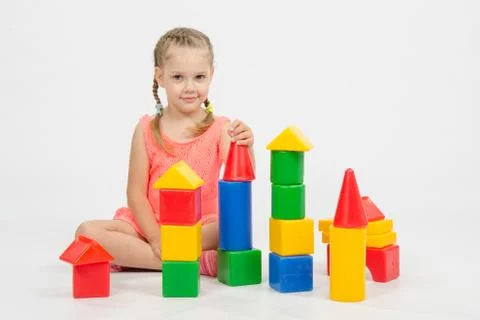 Child cheerfully plays with blocks Stock Photos