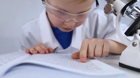 Child chemist. Teacher shows a visual experiment. A science mentor teaches an ex Stock Footage 267007401