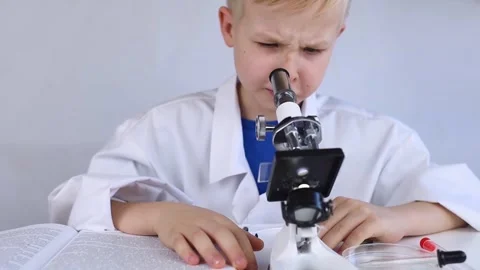Child chemist. Teacher shows a visual experiment. A science mentor teaches an ex Stock Footage 267008201