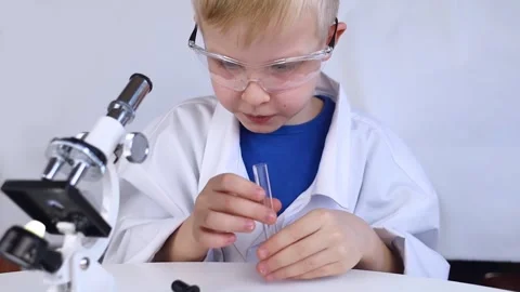 Child chemist. Teacher shows a visual experiment. A science mentor teaches an ex Stock Footage 267008446