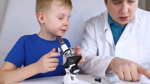 Child chemist. Teacher shows a visual experiment. A science mentor teaches an ex Stock Footage 267008900