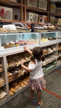 Child choosing bread in a bakery Stock Photos
