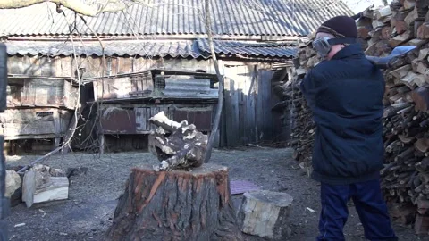 The child chops the stump. Stock Footage 138385960