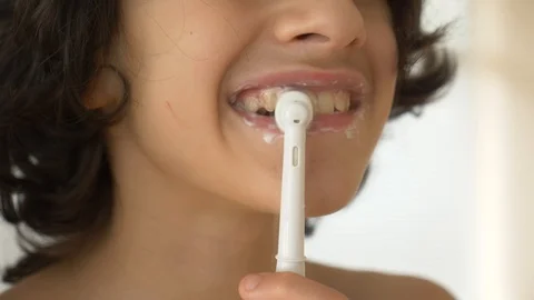 The child cleans his teeth in front of a mirror in 4k. boy teenager brushes Stock Footage 88827539