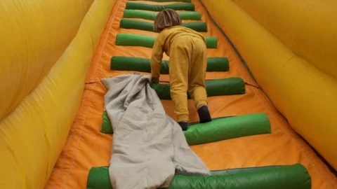 Child climbing on Bouncy Castle Stock Footage 113456687