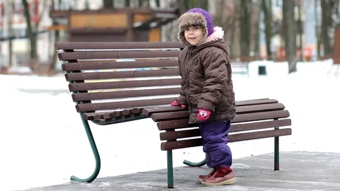 Child climbing on high bench and sit on it Stock Footage 123533614