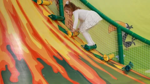 Child climbing the volcano, overcomes obstacles and goes down the hill. Baby Video stock 149732794