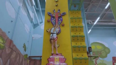 A child on a climbing wall, a climbing wall Видео 337322223