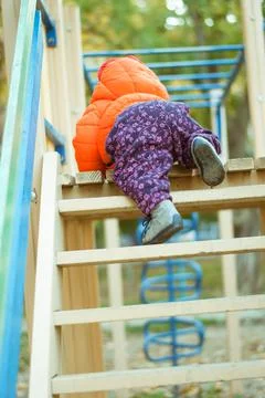 The child climbs the steps on the playground Stock Photos