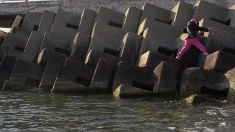 The child climbs the tetrapods Stock Footage 307385156