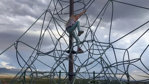 Child climbs to the top of playground structure HD Video stock 80237781