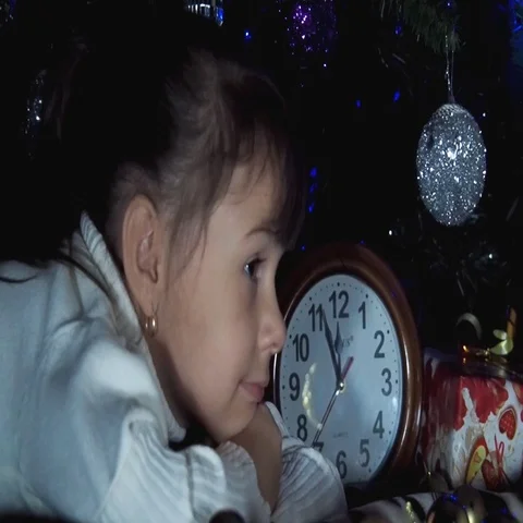 Child with clock under the tree awaiting the offensive magic Video stock 69368435