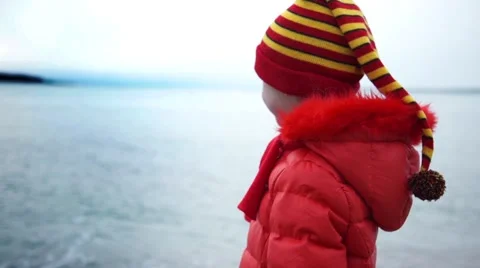 Child close to a  winter sea background Video stock 59665681