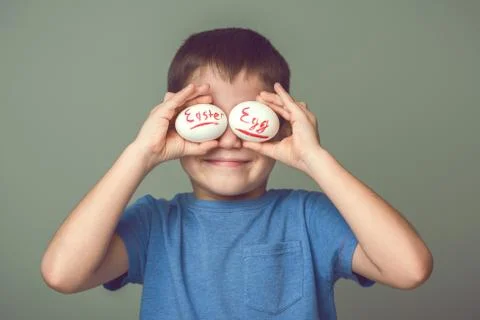 The child closes his eyes Easter eggs Stock Photos
