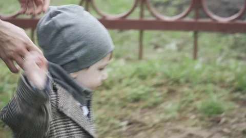 Child in a coat adjust clothes Stock Footage 129889453