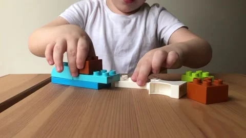A child collects a car from a blocks constructor video Video stock 228652683