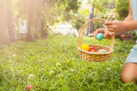 Child collects Easter eggs hunt Stock Photos