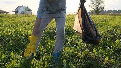 The child collects garbage in the bag. Stock Footage 120733801