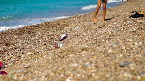 A child collects garbage on the beach. Selective focus. Stock Footage 166045576