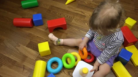 The child collects a pyramid of rings developing logical thinking Stock Footage 96409751