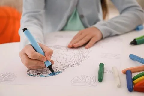 Child coloring drawing at table in room, closeup Foto stock