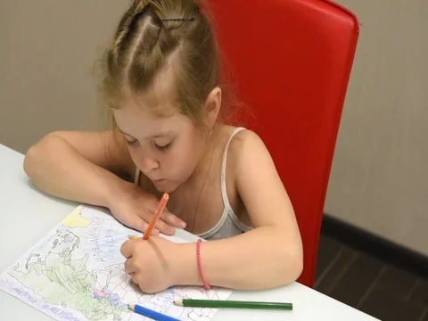 Child colors the world map Stock Footage 74424780