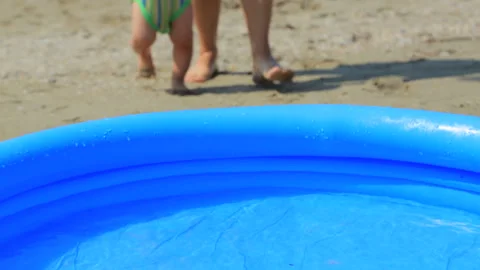 The child comes to the pool by the sea 스톡 동영상 98480925