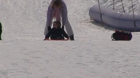Child coming down on a Sledge. Stock Footage 1037998