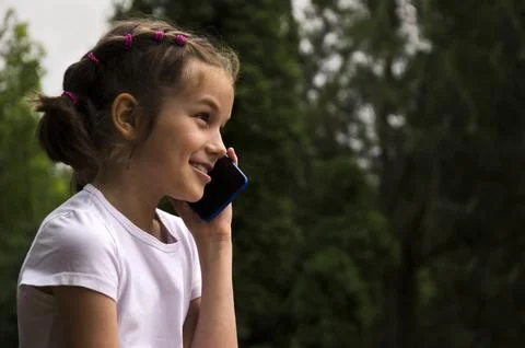 The child communicates on the phone Stock Photos